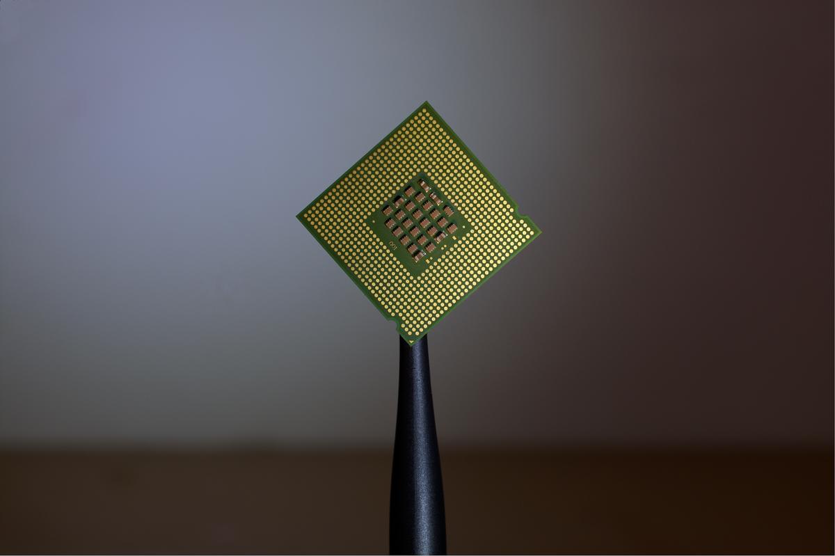 A computer chip with binary code on it to represent the idea of machine learning, symbolizing how data is processed by algorithms to learn and improve over time.
